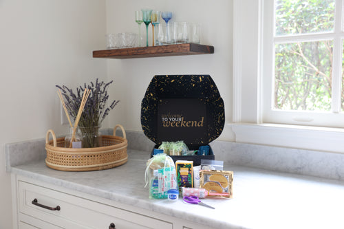 Product display on a countertop with a decorative box and various items.