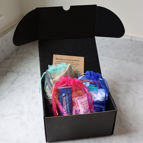Black box with colorful items on a marble surface